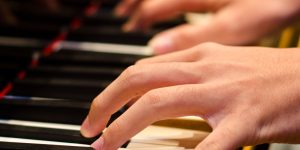 Hand of a pianist playing on a piano